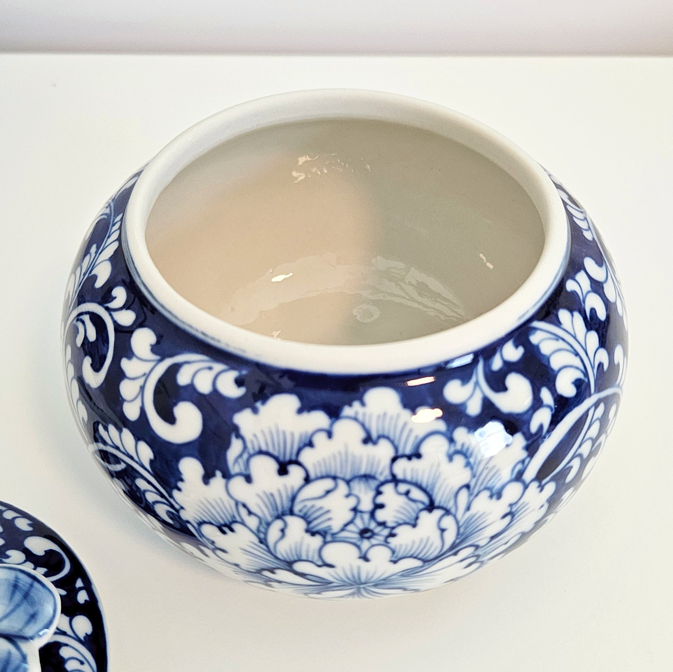 round chinoiserie jar with dragonfly lid showing the interior and glaze