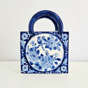 Hand-painted blue and white chinoiserie ceramic purse vase with peony and birds motif