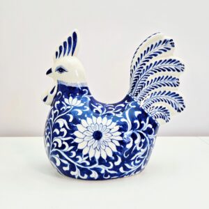 Hand-painted blue and white chinoiserie porcelain rooster figurine with blooming vine motif