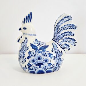 Hand-painted blue and white chinoiserie porcelain rooster figurine with floral motif