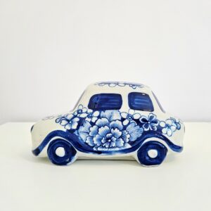 Hand-painted blue and white chinoiserie ceramic car figurine with floral motif