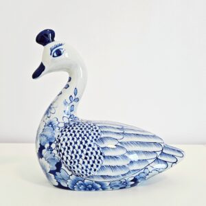 Hand-painted blue and white chinoiserie ceramic swan figurine with floral motif